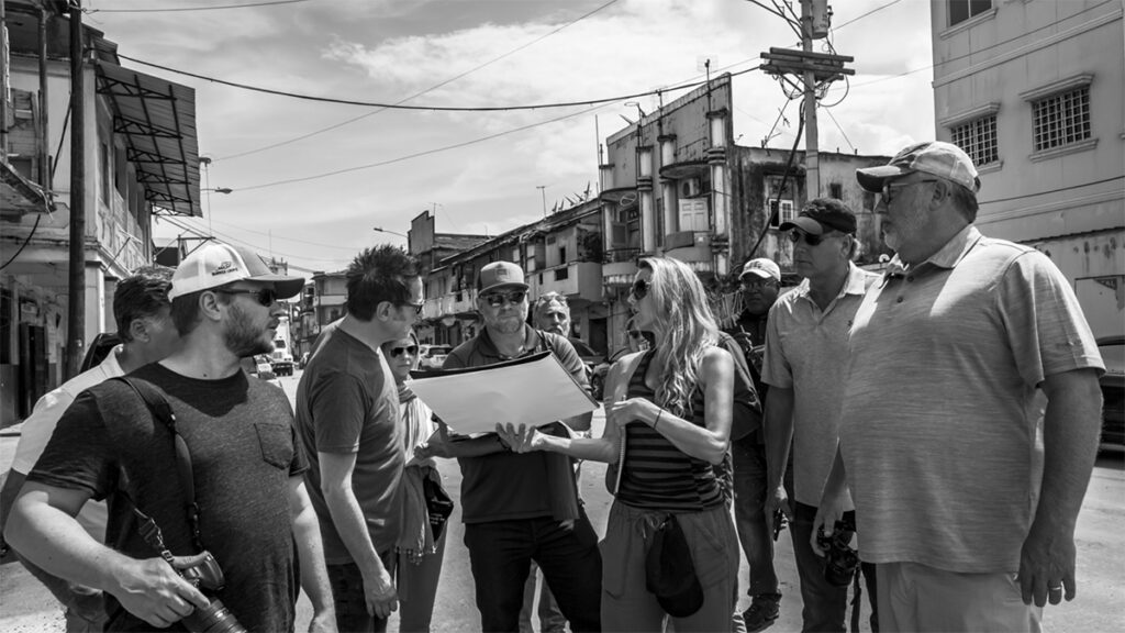Beth Mickle on "The Suicide Squad" set with director James Gunn and additional crew.